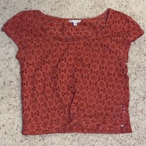 Cute burnt orange hole patterned top